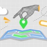 Hand placing a map pin on a folded map with a search bar, representing local search
